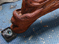 Prehistoric monster-head with internal marble run exiting at snout